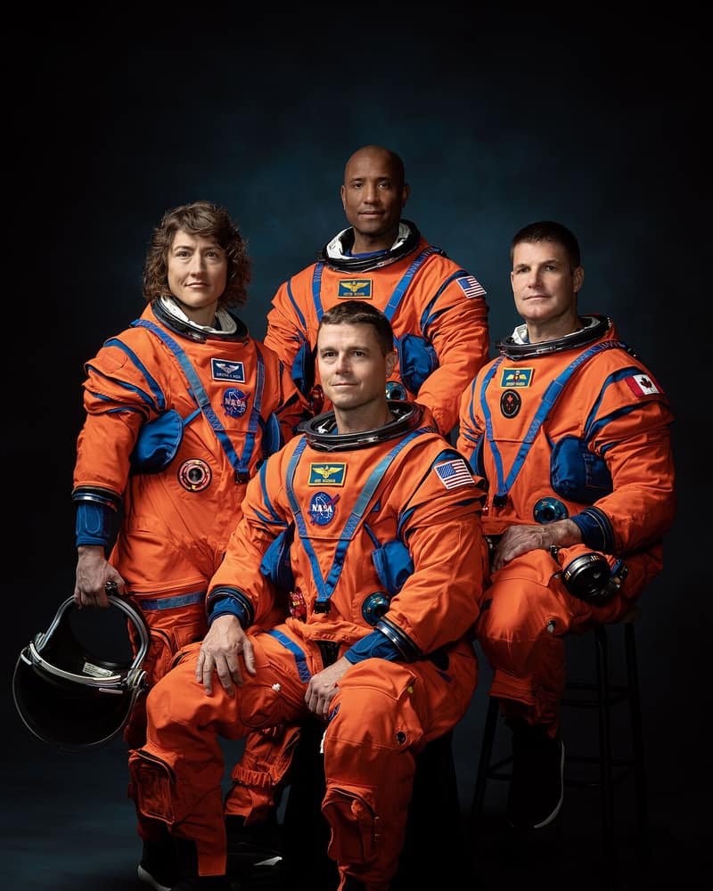 Os quatro astronautas da Artemis II de macacão laranja, posando para a foto oficial